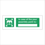 FS213 In Case Of Fire Your Assembly Point Is:- Sign with Four Arrows Pointing To Group Of People