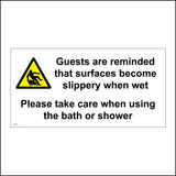 WS775 Guests Are Reminded That Surfaces Become Slippery When Wet Please Take Care When Using The Bath Or Shower Sign with Triangle Person Slipping